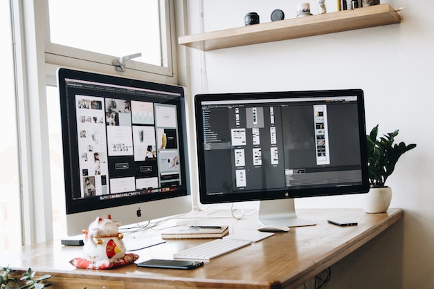 two monitors with different image layouts for marketing